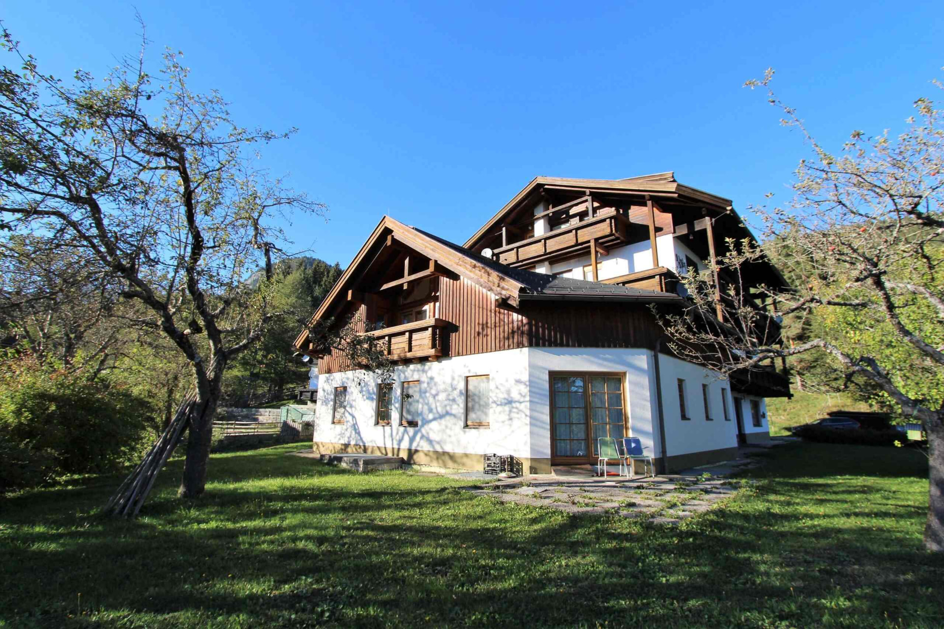 The alpine guest house seen from the garden on a sunny autumn day