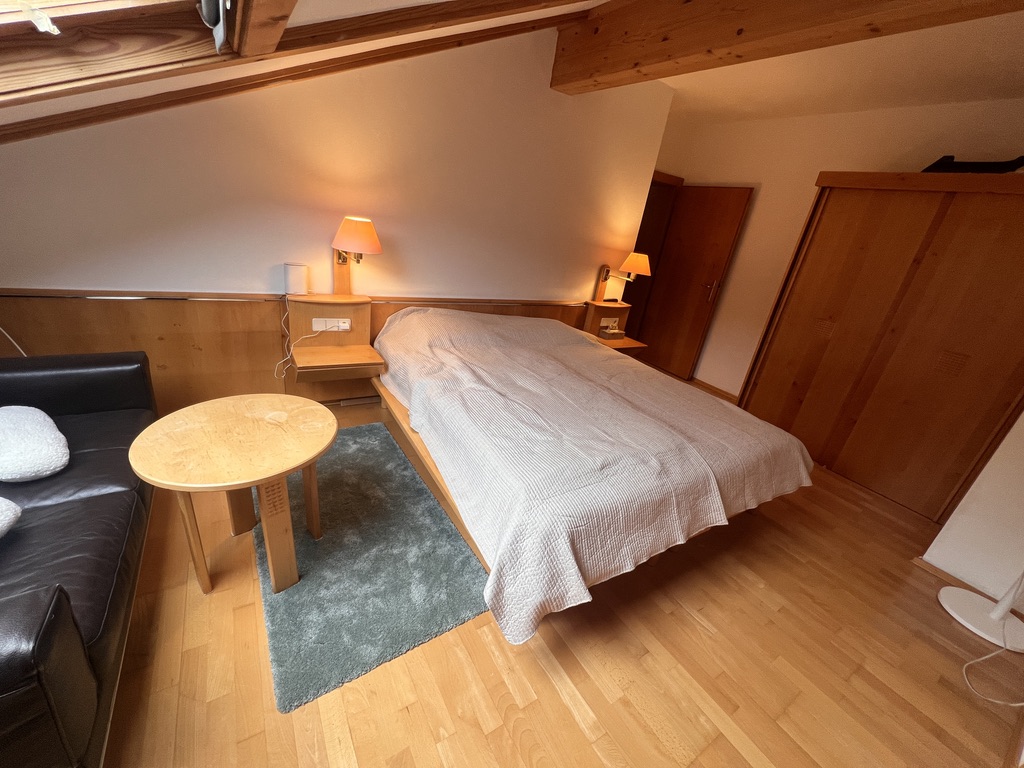 Bedroom with wardrobe, leather sofa and side table