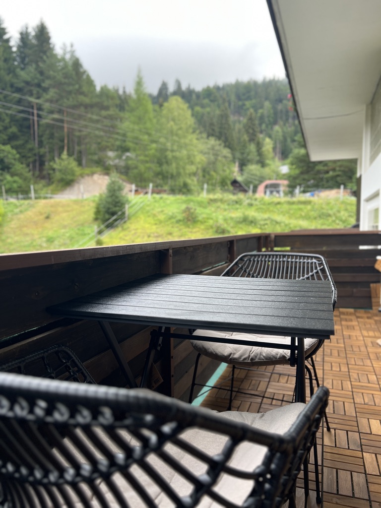 Covered balcony seating looking out over the green valley