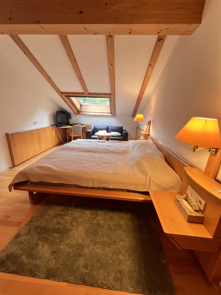 Bedroom with reading corner, sofa and desk by the skylight